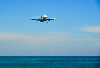 Fototapeta na wymiar Airplane landing at Phuket Airport (Thailand)