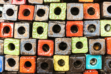 Fototapeta premium Multicolored decorated cubes brick wall with hole design as the abstract textured and background