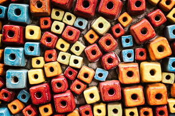 Fototapeta premium Multicolored decorated cubes brick wall with hole design as the abstract textured and background
