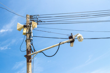 Horn speakers or Loudspeakers and old CCTV security camera on the electric pole in the urban area...