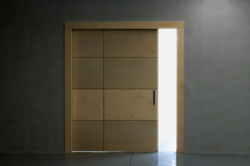 a light emanating from the crevice of a slightly open wooden door.
