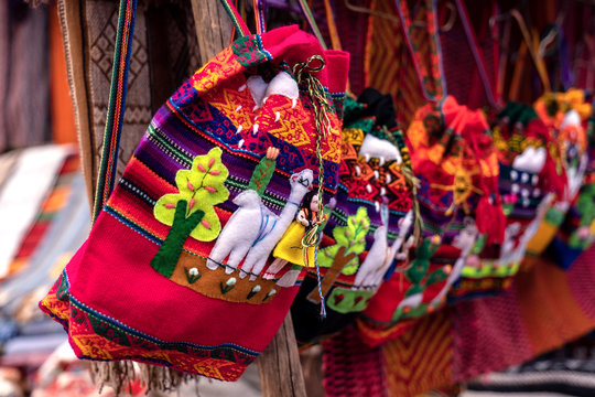 Colorful Peruvian artisanal textiles bag with inca and traditional patterns for sale at street Indian market in Pisac, Sacred Valley, Cusco.