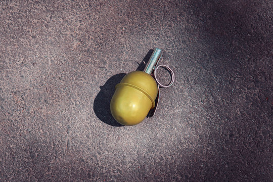 Hand grenade RGD-5 on asphalt. abandoned lost pomegranate green on the pavement. fragmentation grenade.