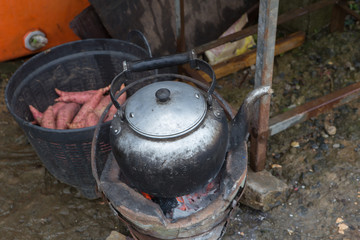 Hot water kettle on a charcoal stove  Blurred background image