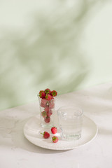 Obraz na płótnie Canvas Fresh raspberries in a glass beaker isolated on light background