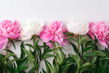 Flowers frame on white wooden background. Seasonal holiday romance, saint valentine, 8 march celebration, Top view with copy space