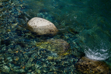 Flow of lake water on stone.