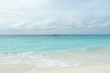 tropical beach and a boat on the  sea