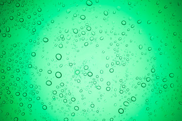 Rain droplets on green glass background, Water drops on glass.
