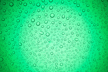 Rain droplets on green glass background, Water drops on glass.