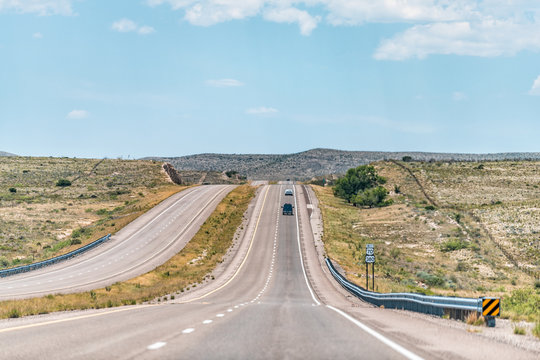 Roswell New Mexico countryside rural town road view from 380 highway with desert landscape and cars, sign for 70 west