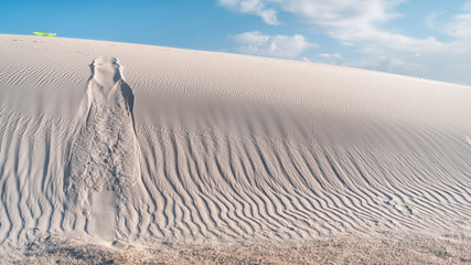 White sands dunes national monument in New Mexico and pattern from disk sled for sliding down hills