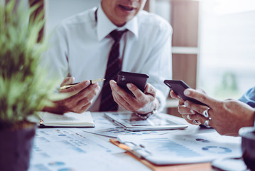 Middle-age Asian two business managers crew working with new startup project while sitting.