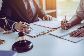 Group of middle age Asian business people and lawyers discussing and sign a contract.