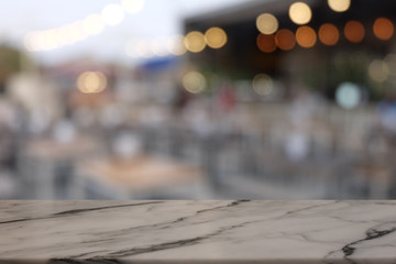 Empty rock table in front of abstract blurred bokeh background of restaurant . can be used for display or montage your products.Mock up for space