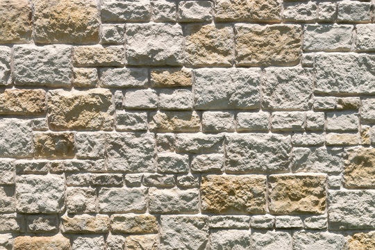 Uneven textures and patterns of a stone brick wall