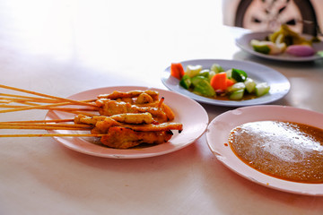 grilled porked with coconut curry and vegetable named satay dish, street food in Asian countries and Thailand