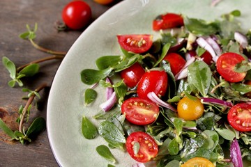 salad with purslane and cherry tomatoes.  concept of organic food from the environment. edible weeds and grass. Purslane is a useful herb. eat the weeds, wild food, eat wild food, wild greens