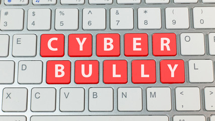 cyber bullying red button on silver keyboard ..