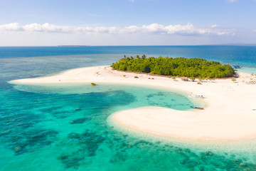 Patawan island. Small tropical island with white sandy beach. Beautiful island on the atoll, view from above. Nature of the Philippine Islands.