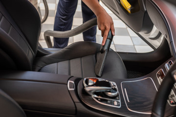 Cleaning of interior of the car with vacuum cleaner