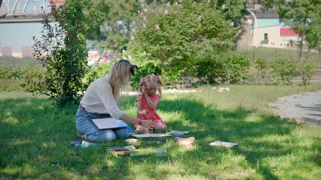 Educational Classes Drawing in Nature. Woman with Little Girl Holding a Watercolor Painting Lessons in a City Park. Art Therapy. Children's Creativity and Painting Science.