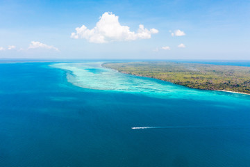 Large islands located on the atolls, a top view. Island with forest.