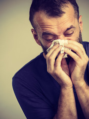 Man blowing nose