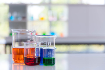 The beaker on the whit desk in laboratory.