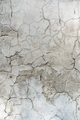 background cracked white wall. White plaster cracked. Cracks on the white wall. Grid on a white plaster wall texture.