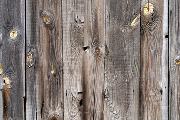 old peeling wooden boards. Background natural wooden boards. Texture of old unpainted wooden planks. Vertical arrangement of shabby wooden boards.