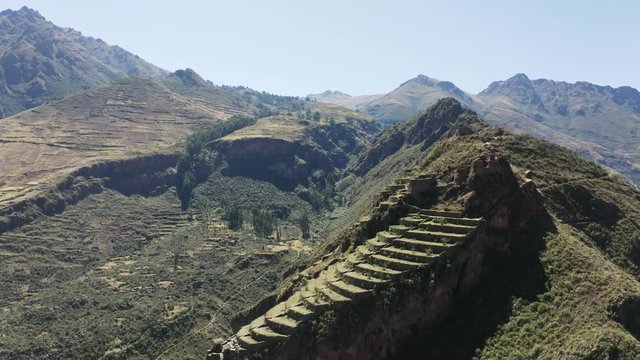 Aerial view of the ancient Inca ruins of Pisac (Pisaq) in the Sacred Valley near Cusco, Peru. Archaeological park with green terraces.