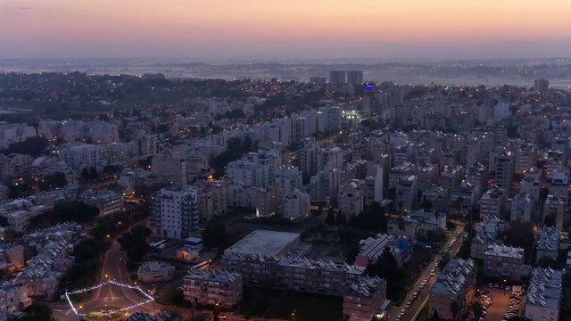 Aerial Time Lapse of a residential neighborhood in a city during a vibrant and colorful sunrise. Taken in Netanya, Center District, Israel.