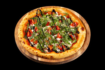 Italian pizza with herbs, mozzarella and tomatoes on wooden tray isolated at black backgound.