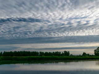 Sunlight and cloud formations in the sky and water , Latvia