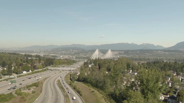 Aerial view of Trans-Canada Highway over the Port Mann Bridge during a sunny day. Taken in Surrey, Greater Vancouver, British Columbia, Canada.