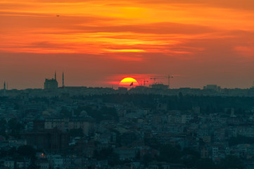 Vivid red orange sky and sun setting Istanbul aerial view
