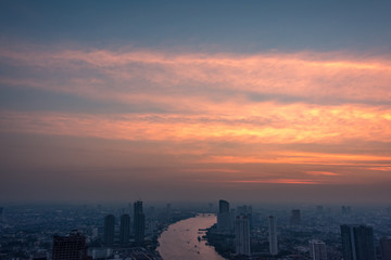 Colorful sunset sky above Asian city with river