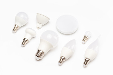 Group of different energy saving lamps isolated at yellow background.