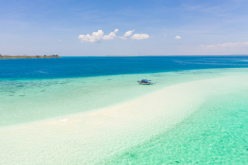 Fototapeta na wymiar Mansalangan sandbar, Balabac, Palawan, Philippines. Tropical islands with turquoise lagoons, view from above. Boat and tourists in shallow water.