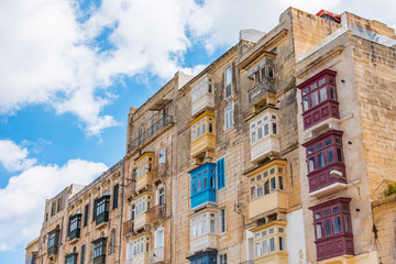 Many typical traditional balconies in a residential building of the town of Valletta Malta.