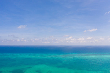 Obraz premium Coral reefs and atolls in the tropical sea, top view. Turquoise sea water and beautiful shallows. Philippine nature.