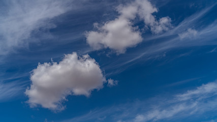 white clouds float across the blue sky