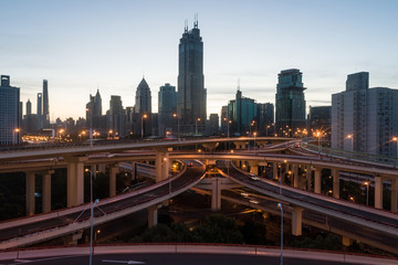 Fototapeta na wymiar aerial view of buildings and highway interchange at dawn in Shanghai city