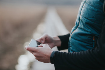 Handsome young influencer man using a smartphone