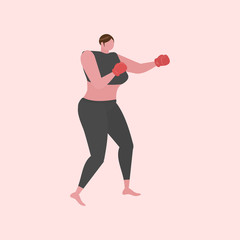 An athletic woman training for boxing with red gloves