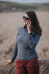 Woman using a smartphone outdoors in a rural environment