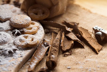 Sweet Biscuits on cutting board and canvas with powder on wooden table, vintage style. Royalty high quality free stock image.