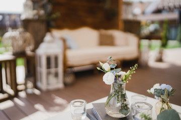 Coziness and style. Modern event design. Lounge and photo zone and european traditional wedding ceremony decoration outdoors in the restaurant before the reception.