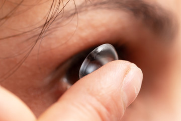 Fototapeta premium installing an ophthalmic lens with your finger